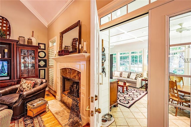 6369 Timber Creek Trl, Dahlonega, GA 30533 - living area with a fireplace, lofted ceiling, ornamental molding, and light tile patterned floors