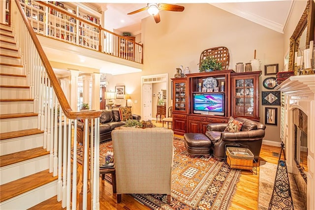 6369 Timber Creek Trl, Dahlonega, GA 30533 - living room featuring ceiling fan, a fireplace, wood finished floors, stairs, and ornamental molding