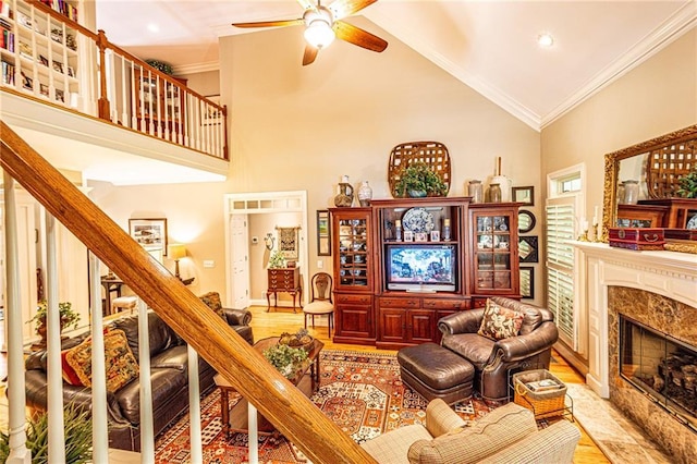 6369 Timber Creek Trl, Dahlonega, GA 30533 - living area featuring a ceiling fan, wood finished floors, crown molding, high vaulted ceiling, and a high end fireplace