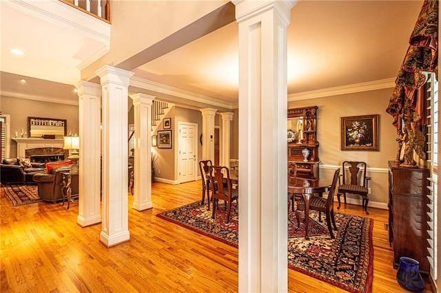 6369 Timber Creek Trl, Dahlonega, GA 30533 - foyer entrance with decorative columns, a fireplace, crown molding, light wood finished floors, and recessed lighting