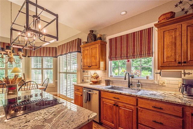 6369 Timber Creek Trl, Dahlonega, GA 30533 - kitchen with dishwasher, black electric cooktop, a chandelier, and light stone countertops