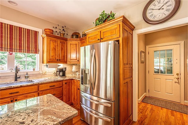 6369 Timber Creek Trl, Dahlonega, GA 30533 - kitchen featuring stainless steel refrigerator with ice dispenser, wood finished floors, brown cabinetry, and vaulted ceiling