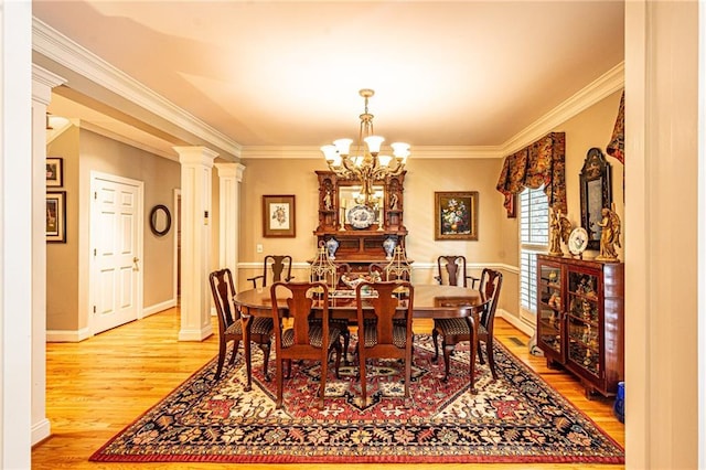 6369 Timber Creek Trl, Dahlonega, GA 30533 - dining area featuring a chandelier, ornamental molding, light wood finished floors, and ornate columns