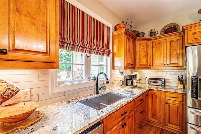 6369 Timber Creek Trl, Dahlonega, GA 30533 - kitchen with stainless steel refrigerator with ice dispenser, decorative backsplash, light stone countertops, and brown cabinetry