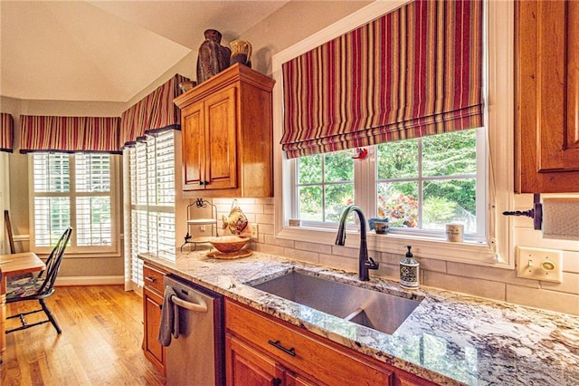 6369 Timber Creek Trl, Dahlonega, GA 30533 - kitchen featuring dishwasher, light wood-style flooring, brown cabinetry, lofted ceiling, and light stone countertops