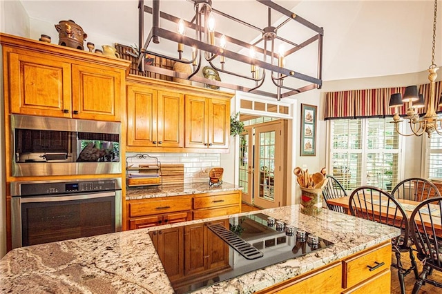 6369 Timber Creek Trl, Dahlonega, GA 30533 - kitchen with stainless steel appliances, a chandelier, healthy amount of natural light, light stone counters, and high vaulted ceiling