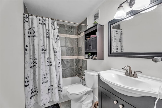 bathroom featuring visible vents, toilet, vanity, and shower / tub combo