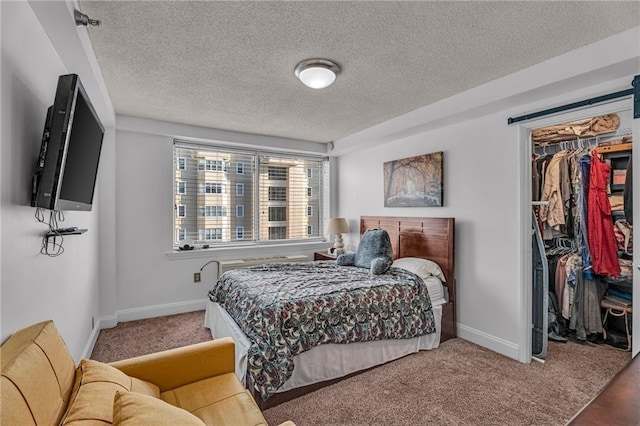 bedroom with a walk in closet, a closet, baseboards, and carpet floors