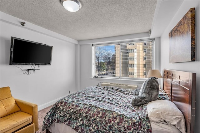 carpeted bedroom featuring baseboards and a textured ceiling