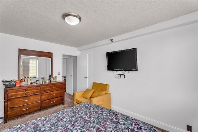 bedroom with baseboards, a textured ceiling, and carpet flooring