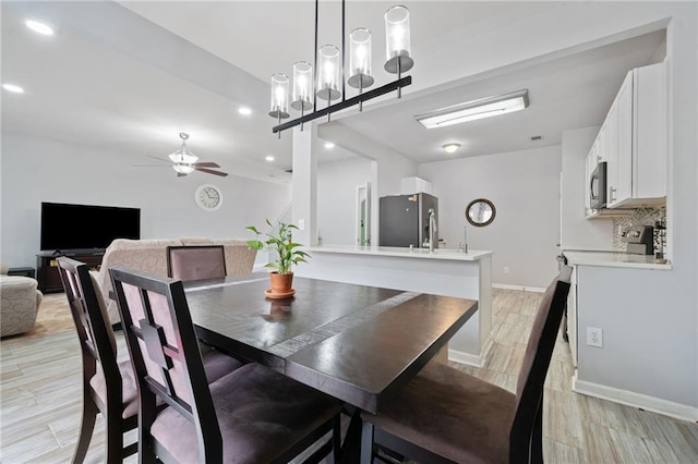 dining area with recessed lighting, light wood-type flooring, baseboards, and a ceiling fan