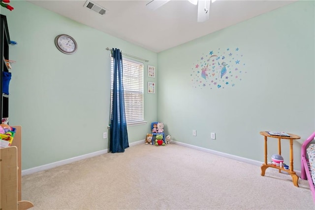 recreation room featuring carpet, a ceiling fan, visible vents, and baseboards