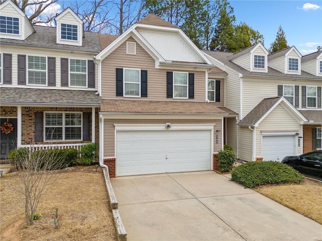 multi unit property featuring a garage, driveway, and a shingled roof