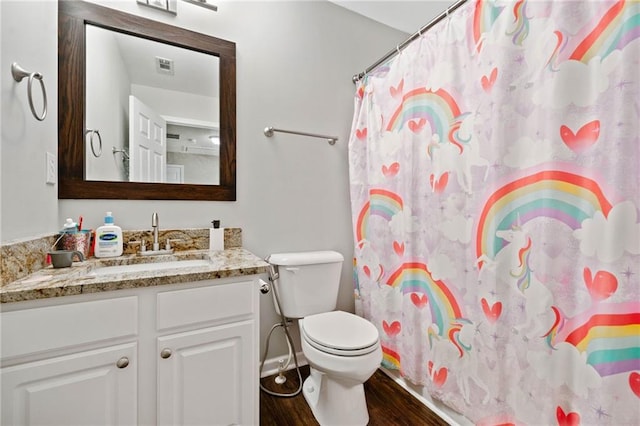 bathroom with vanity, wood finished floors, visible vents, curtained shower, and toilet