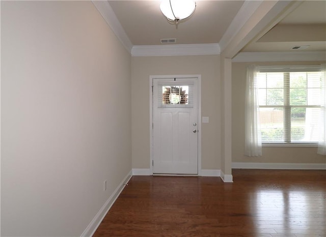 foyer with plenty of natural light, crown molding, wood finished floors, and baseboards