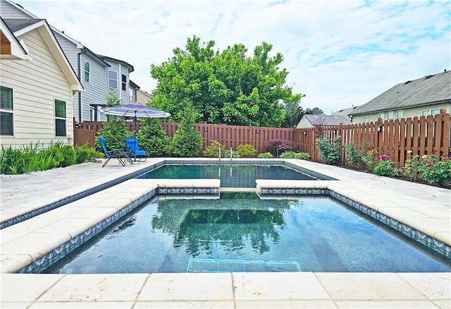 view of swimming pool featuring a fenced backyard, a patio, and a pool with connected hot tub
