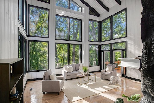2432 Thompson Mill Rd, Gainesville, GA 30506 - sunroom / solarium featuring high vaulted ceiling, beamed ceiling, wood finished floors, and wood walls