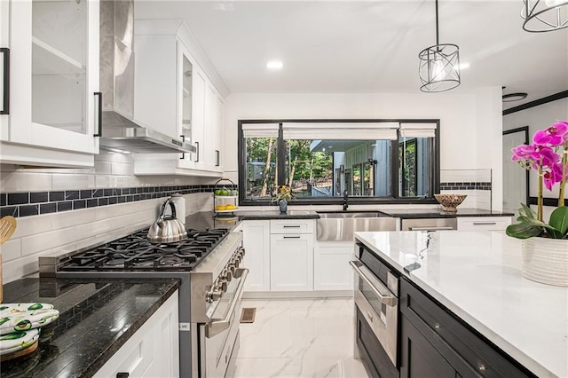 2432 Thompson Mill Rd, Gainesville, GA 30506 - kitchen with appliances with stainless steel finishes, wall chimney exhaust hood, a sink, light marble finish flooring, and white cabinetry