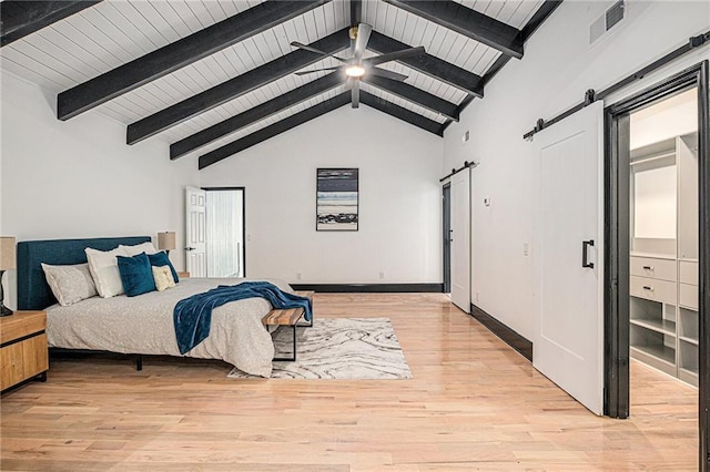 2432 Thompson Mill Rd, Gainesville, GA 30506 - bedroom featuring a barn door, light wood-type flooring, wooden ceiling with exposed beams, high vaulted ceiling, and baseboards