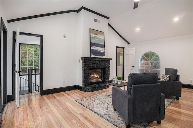 2432 Thompson Mill Rd, Gainesville, GA 30506 - living room with lofted ceiling, healthy amount of natural light, light wood finished floors, baseboards, and a fireplace