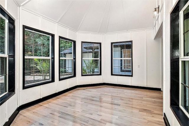 2432 Thompson Mill Rd, Gainesville, GA 30506 - unfurnished sunroom featuring a decorative wall, wood finished floors, a wooden deck, and lofted ceiling