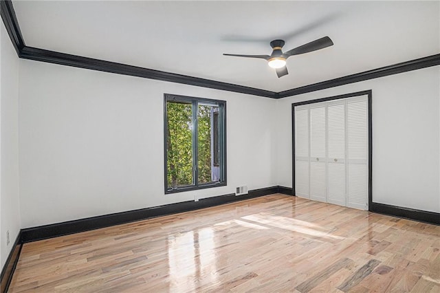 2432 Thompson Mill Rd, Gainesville, GA 30506 - unfurnished bedroom with crown molding, wood finished floors, baseboards, a closet, and ceiling fan
