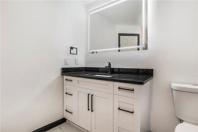 2432 Thompson Mill Rd, Gainesville, GA 30506 - bathroom featuring toilet, vanity, and baseboards
