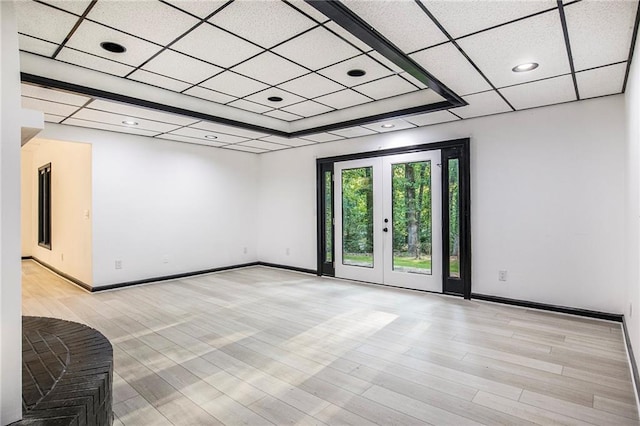 2432 Thompson Mill Rd, Gainesville, GA 30506 - spare room with a paneled ceiling, baseboards, light wood-style flooring, and french doors