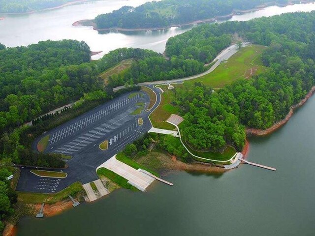 2432 Thompson Mill Rd, Gainesville, GA 30506 - aerial view of property and surrounding area featuring a nearby body of water and a heavily wooded area