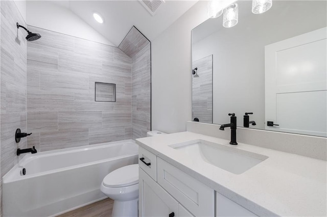 bathroom featuring vanity, shower / bath combination, toilet, visible vents, and wood finished floors
