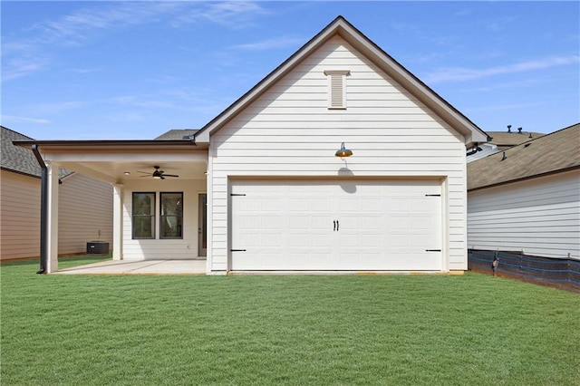 rear view of property featuring a yard, a patio, ceiling fan, and a garage