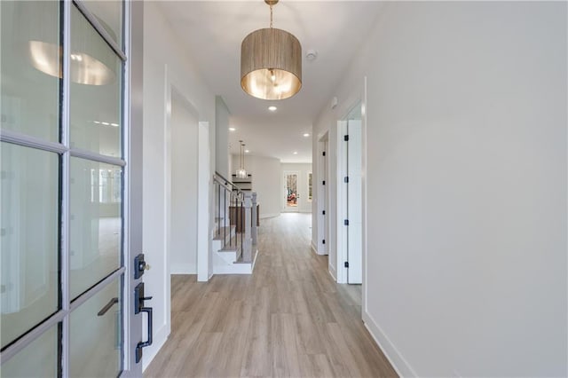 corridor with recessed lighting, light wood-style flooring, and baseboards