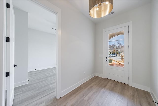 entryway featuring wood finished floors, visible vents, and baseboards