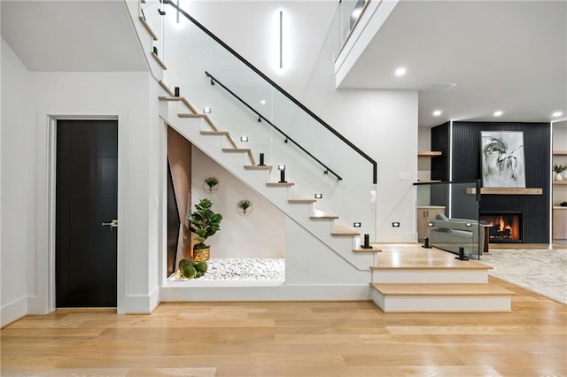 942 Fairfield, Marietta, GA 30068 - stairway with wood finished floors, a warm lit fireplace, baseboards, and recessed lighting