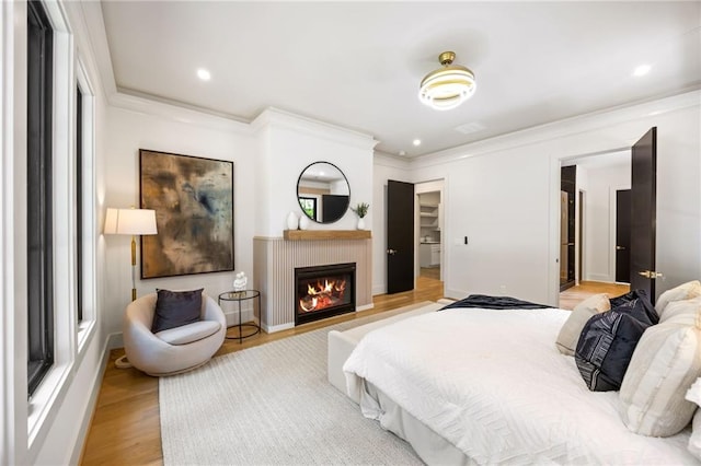 942 Fairfield, Marietta, GA 30068 - bedroom with light wood-style floors, ornamental molding, a warm lit fireplace, and recessed lighting