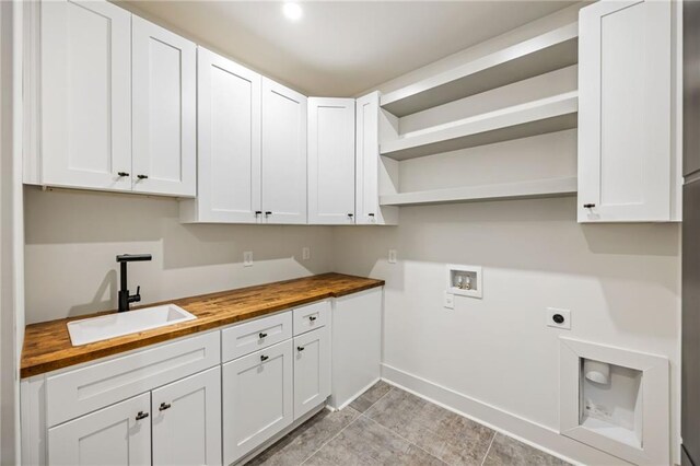 942 Fairfield, Marietta, GA 30068 - laundry area with hookup for an electric dryer, cabinet space, washer hookup, baseboards, and light tile patterned floors