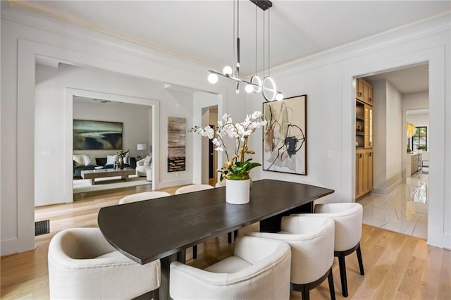 942 Fairfield, Marietta, GA 30068 - dining space featuring light wood-type flooring and crown molding