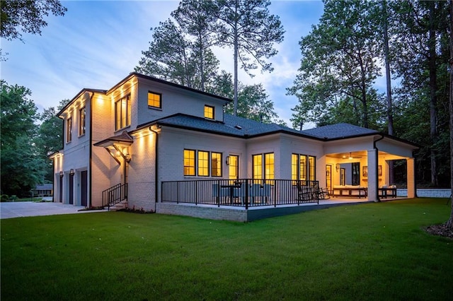 942 Fairfield, Marietta, GA 30068 - rear view of house with a garage, a lawn, brick siding, and driveway