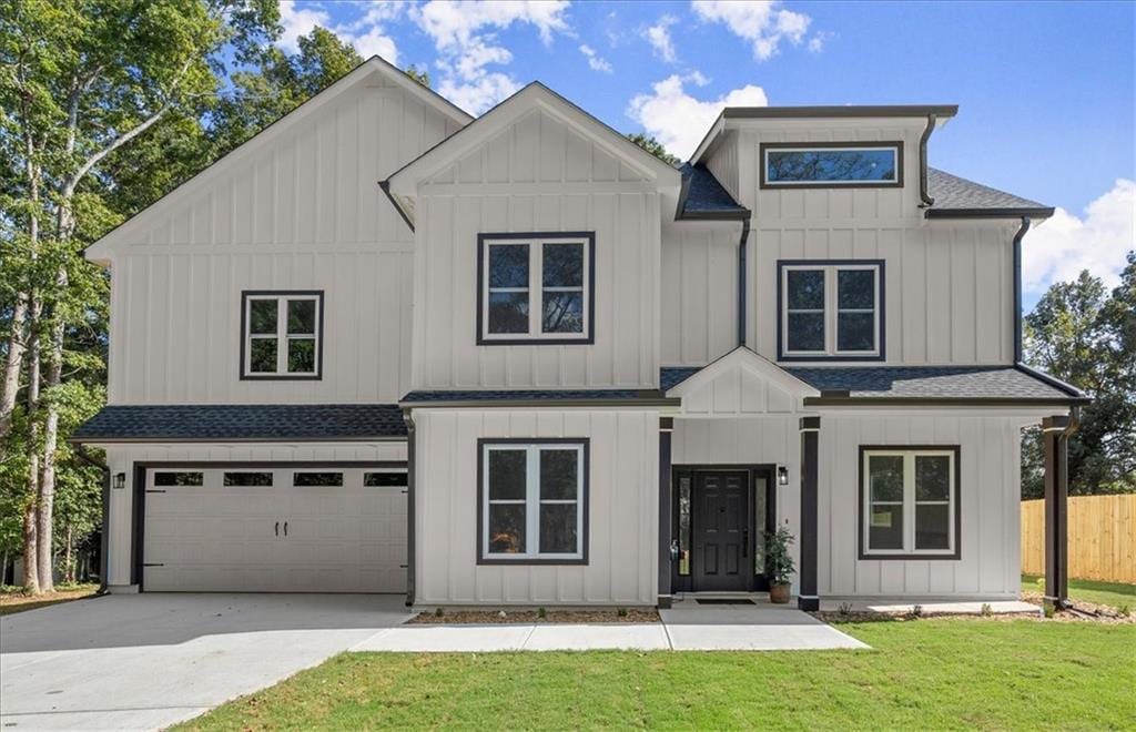 view of front of home with a garage and a front lawn