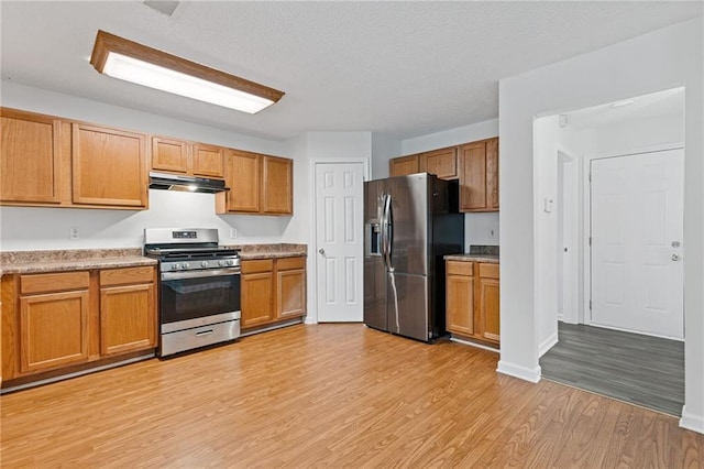 kitchen featuring light hardwood / wood-style floors and appliances with stainless steel finishes