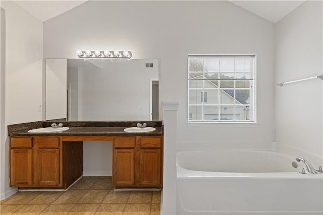 bathroom with lofted ceiling, vanity, and a washtub