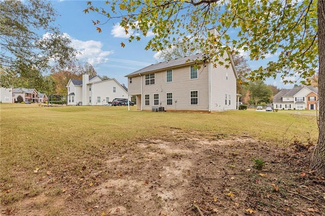 back of property featuring a yard