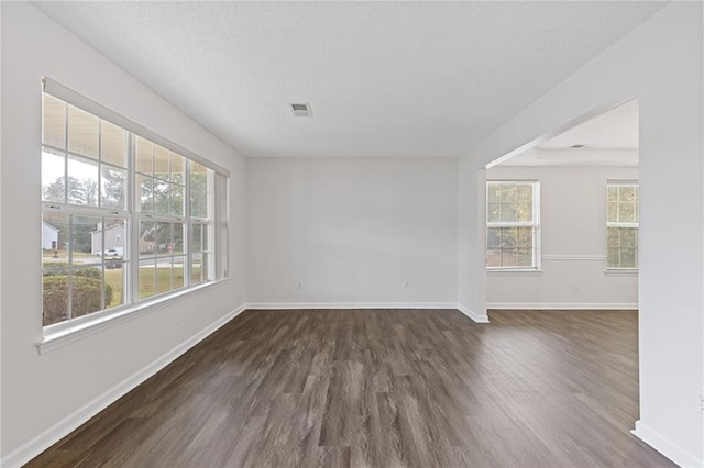 unfurnished room featuring dark wood-type flooring