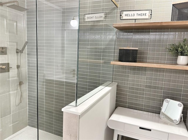 full bathroom featuring tile walls and walk in shower