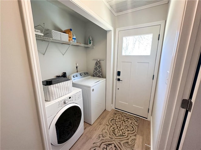 laundry room with washer and dryer, laundry area, and light wood-style flooring