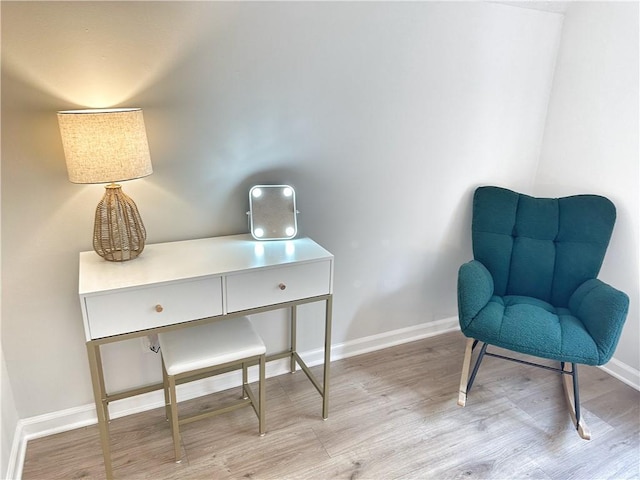 living area with baseboards and light wood-style floors