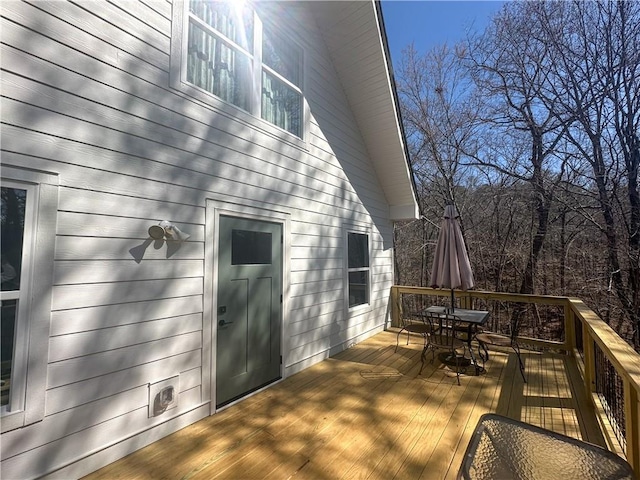 wooden deck featuring outdoor dining area