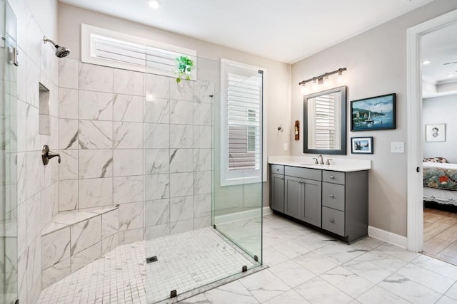 bathroom with a tile shower and vanity