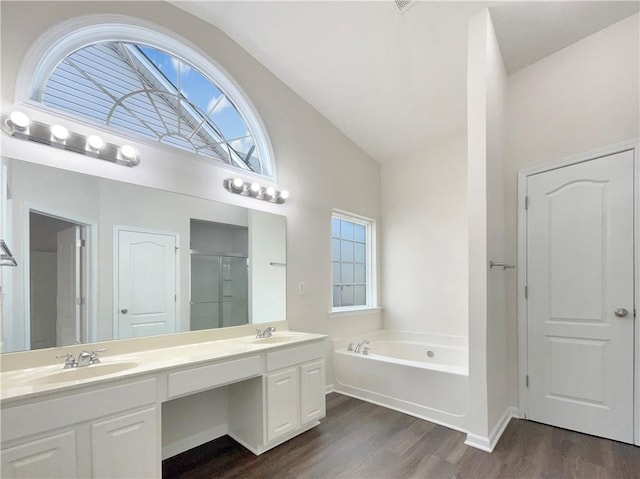 bathroom with separate shower and tub, vanity, lofted ceiling, and hardwood / wood-style flooring