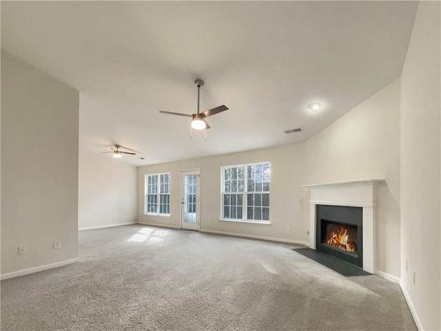 unfurnished living room featuring light colored carpet and ceiling fan